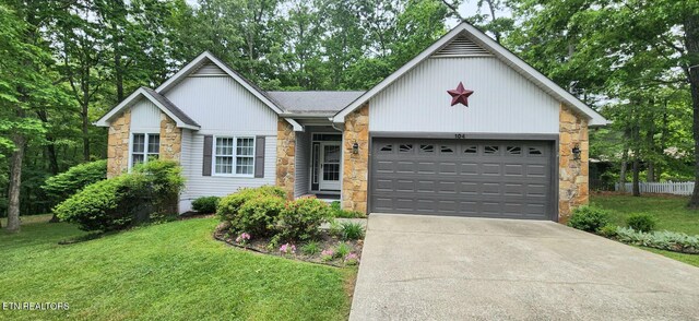 104 Glenwood Dr, Crossville, TN 38558 - ranch-style home with stone siding, roof with shingles, concrete driveway, an attached garage, and a front lawn