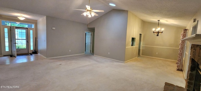 unfurnished living room with a textured ceiling, high vaulted ceiling, light colored carpet, and ceiling fan with notable chandelier