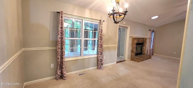 interior space with carpet, a healthy amount of sunlight, an inviting chandelier, and a stone fireplace