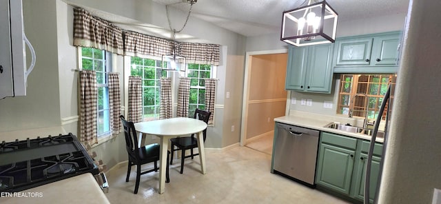 kitchen with appliances with stainless steel finishes, decorative light fixtures, sink, and a textured ceiling