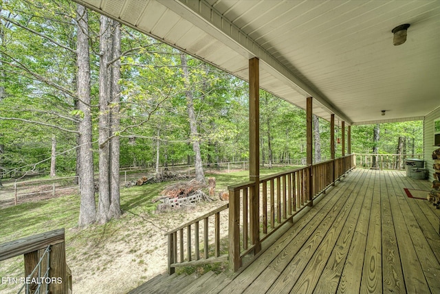 wooden deck with a porch and fence