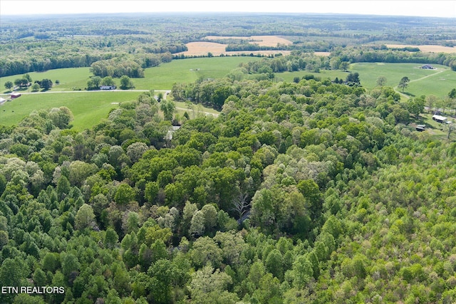 aerial view featuring a view of trees and a rural view