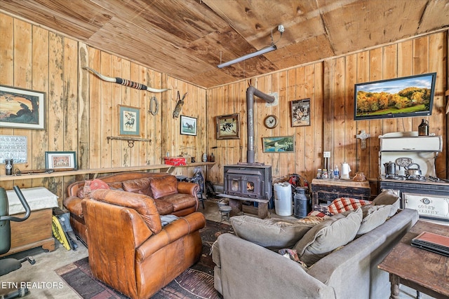 living area featuring a wood stove, wooden ceiling, and wooden walls