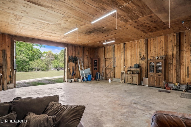 garage with wooden ceiling and wooden walls