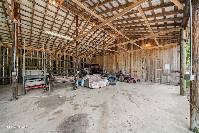 misc room featuring lofted ceiling and concrete floors