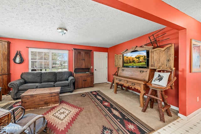 living area with a textured ceiling, light colored carpet, and baseboards