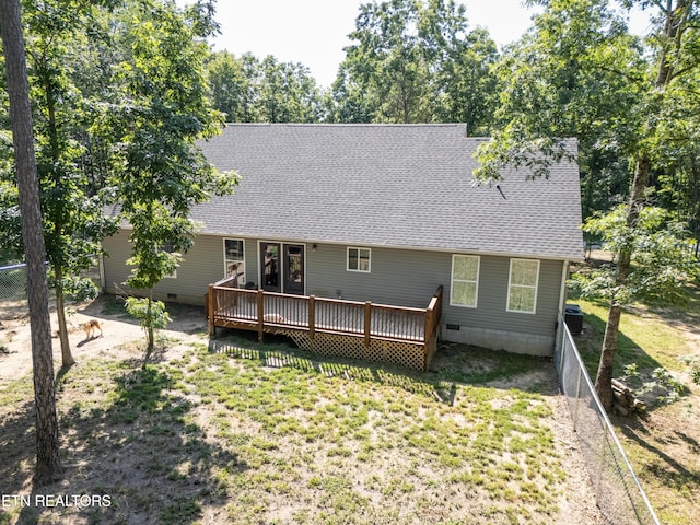 rear view of property featuring a deck, central AC unit, and a yard