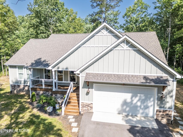 view of front facade with a porch, a garage, and a front yard