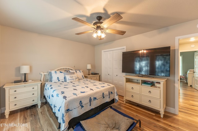 bedroom featuring ceiling fan, light hardwood / wood-style flooring, and a closet