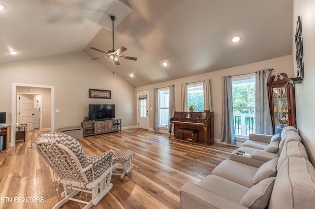 living room featuring high vaulted ceiling, hardwood / wood-style floors, and ceiling fan