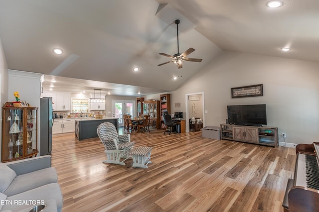 living room featuring sink, high vaulted ceiling, ceiling fan, and light hardwood / wood-style flooring