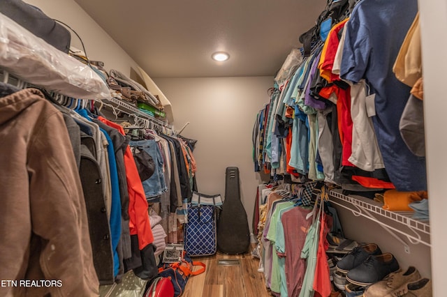 walk in closet with hardwood / wood-style floors