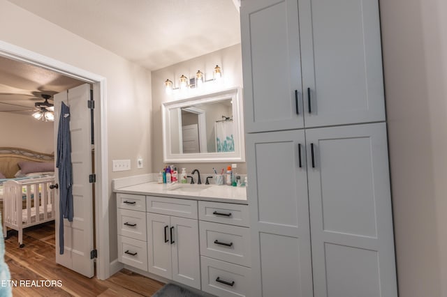 bathroom featuring hardwood / wood-style flooring, ceiling fan, and vanity