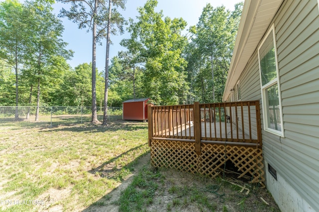 view of yard with a storage shed and a wooden deck