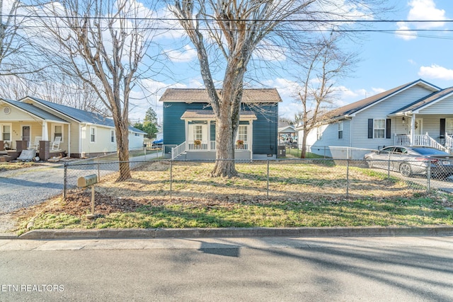 bungalow-style house with a fenced front yard and a residential view