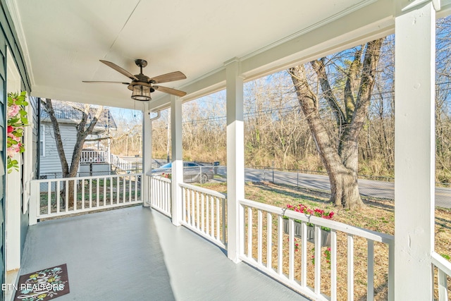 unfurnished sunroom with a ceiling fan