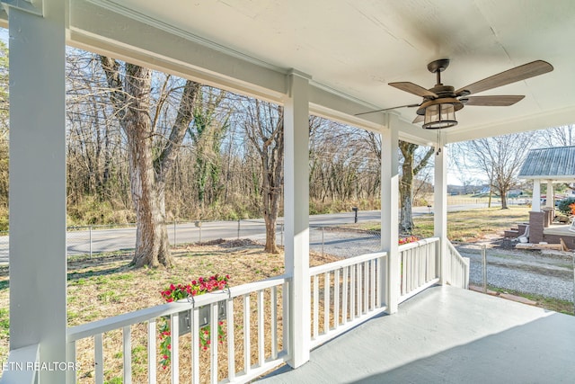 view of patio / terrace with a porch, fence, and a ceiling fan