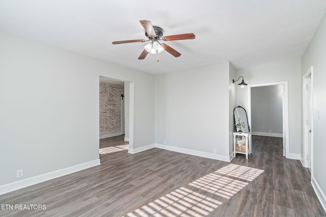 unfurnished room featuring ceiling fan, baseboards, and wood finished floors