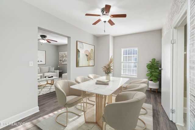 dining area with a ceiling fan, baseboards, and wood finished floors