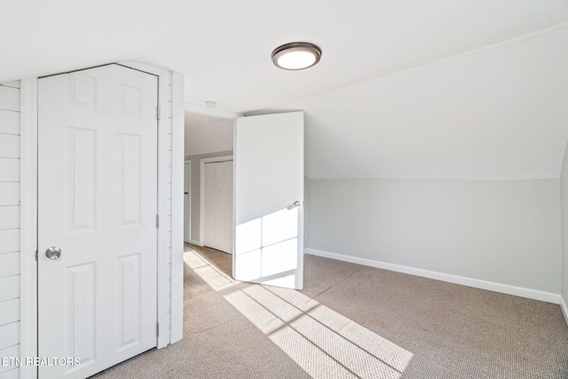 bonus room with vaulted ceiling, carpet flooring, and baseboards