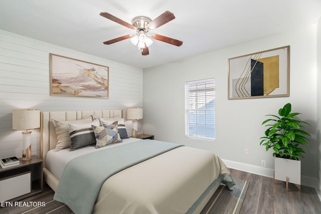 bedroom featuring a ceiling fan, baseboards, and wood finished floors