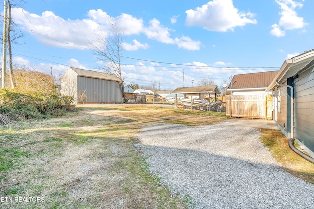 view of road with gravel driveway and a gated entry