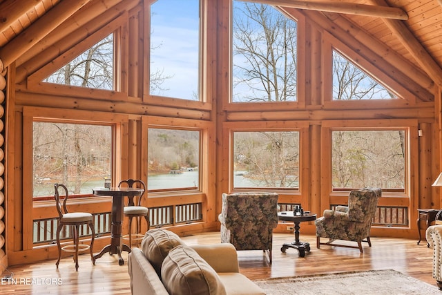 interior space with wood ceiling, beam ceiling, a healthy amount of sunlight, and wood finished floors