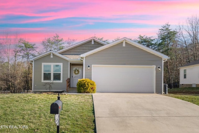 single story home featuring a yard, an attached garage, and driveway