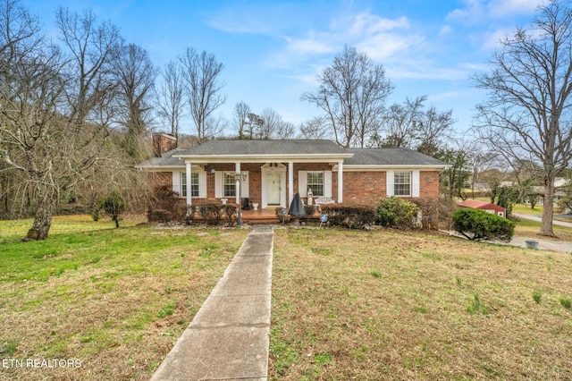 single story home with covered porch and a front lawn