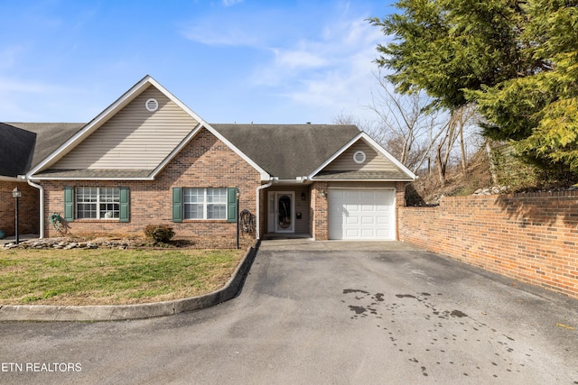 view of front of property featuring a front yard and a garage