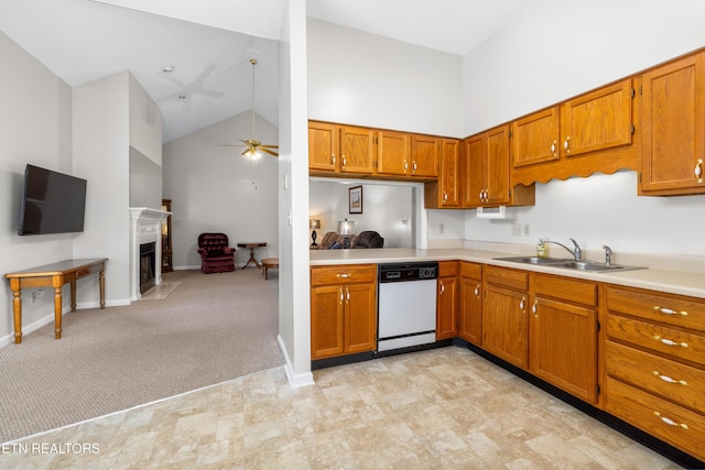 kitchen featuring sink, dishwasher, ceiling fan, light carpet, and high vaulted ceiling