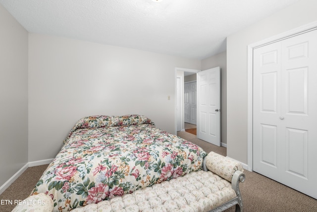 bedroom with carpet floors and a textured ceiling