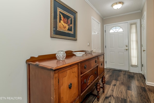 entrance foyer featuring a textured ceiling, ornamental molding, and dark hardwood / wood-style flooring