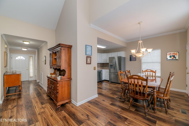 dining room with a chandelier, dark hardwood / wood-style flooring, ornamental molding, and a towering ceiling