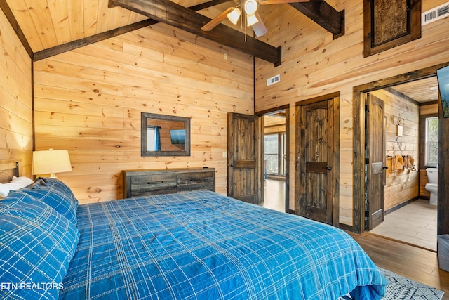 bedroom featuring visible vents and wooden walls