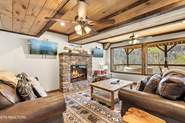 living area featuring a wealth of natural light, wooden ceiling, a fireplace, and light wood-style flooring