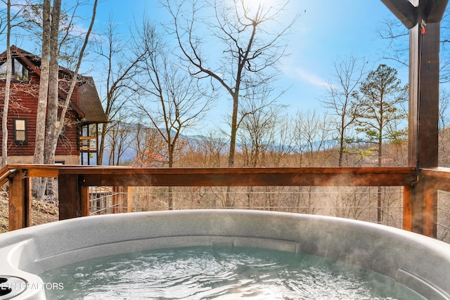 view of pool with a hot tub