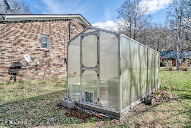 view of outbuilding featuring a lawn