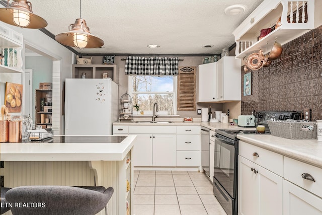 kitchen featuring sink, light tile patterned flooring, pendant lighting, black appliances, and white cabinets