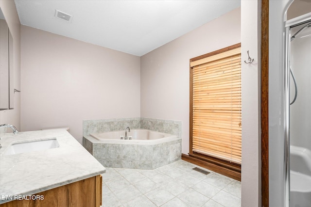 bathroom with a garden tub, tile patterned flooring, visible vents, and vanity