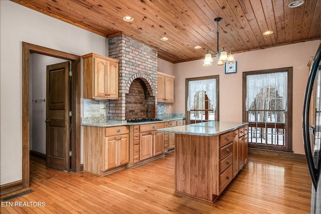 kitchen with plenty of natural light, a kitchen island, and wood ceiling