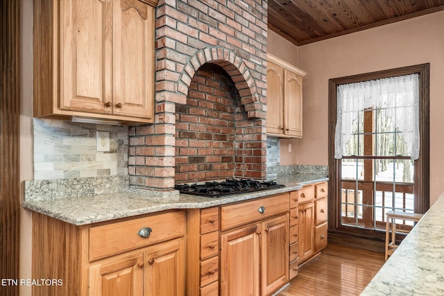 kitchen featuring decorative backsplash, wooden ceiling, light stone countertops, light wood-type flooring, and black gas stovetop