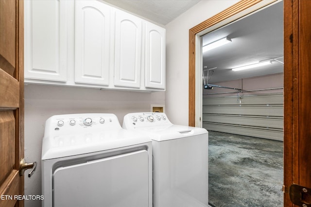 laundry area with a garage, cabinet space, and washing machine and dryer