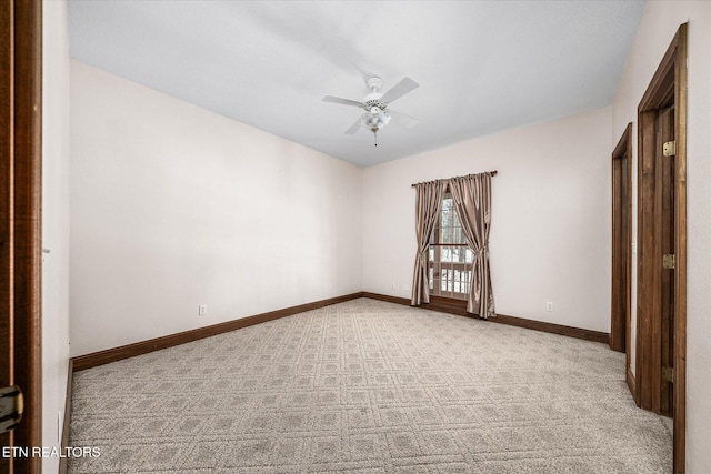 empty room featuring a ceiling fan, carpet floors, and baseboards