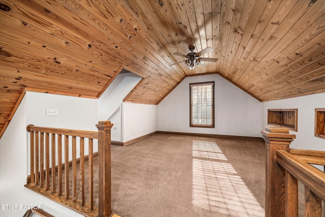 additional living space with wooden ceiling, carpet, baseboards, and vaulted ceiling