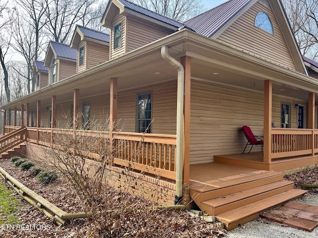 view of home's exterior with a porch and metal roof