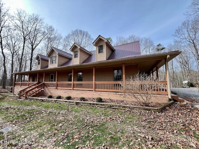 view of front of property featuring covered porch and metal roof