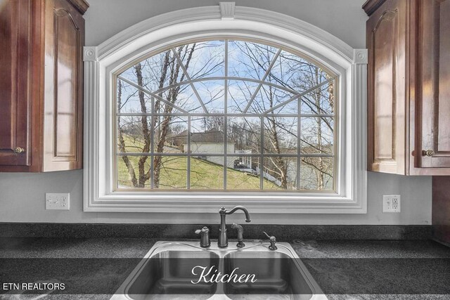 kitchen with dark countertops and a sink