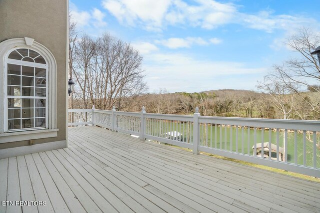 wooden deck featuring a water view