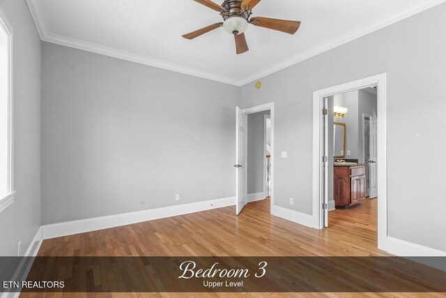 unfurnished bedroom featuring crown molding, light wood-style flooring, and baseboards